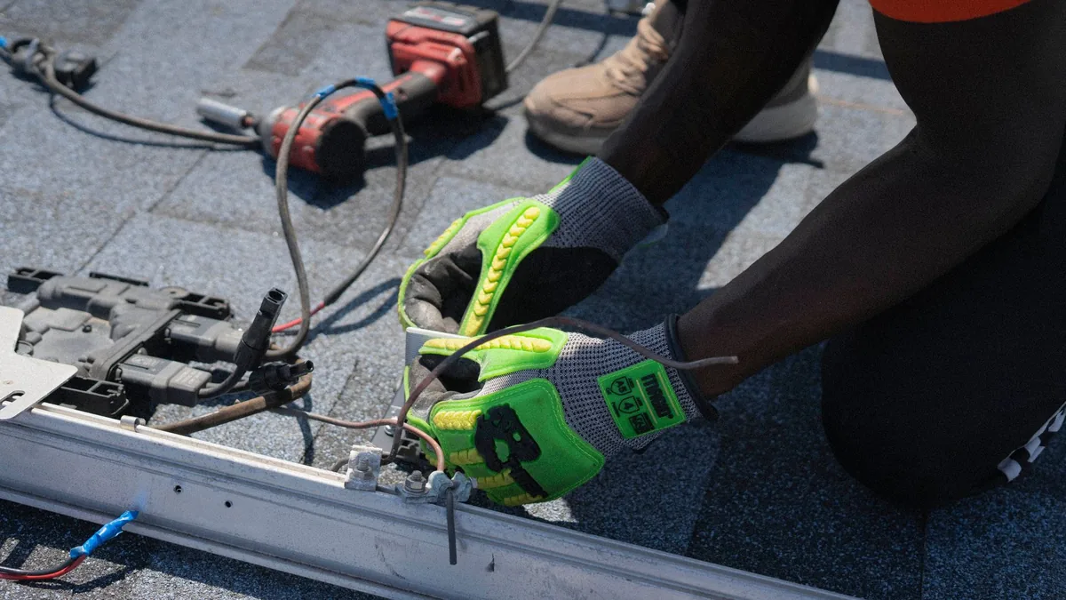 Installers mounting solar panels on a house roof in Durham, NC